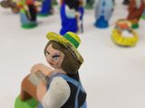 many figurines of people that are on a table