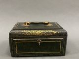 a small black box with gold trimming on it