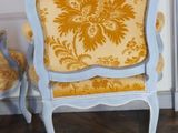 a chair with a yellow and blue upholstered back
