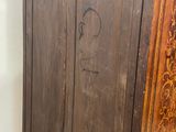 a wooden cabinet with a door on it in a room