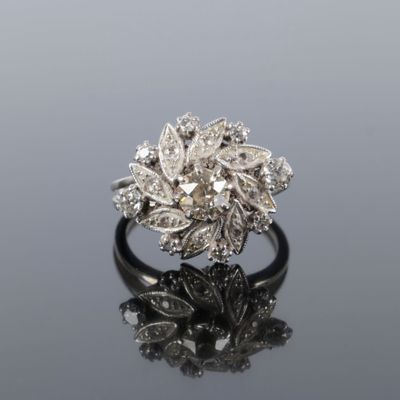 a close up of a diamond ring on a reflective surface