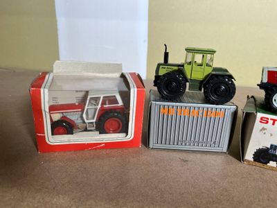 three toy vehicles that are sitting next to each other