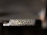 a close up of a piece of metal with a hole in it