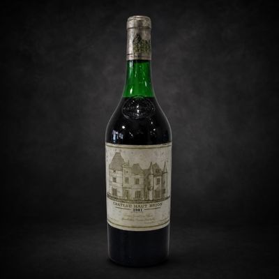 a bottle of wine sitting on top of a black table
