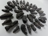 a lot of black rocks on a white surface