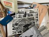 a pile of old photos and postcards sitting on a table
