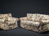 deux canapés et un fauteuil dans une pièce sombre