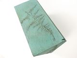 a green box with writing on it sitting on a table