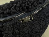 a close up of a black purse with a zipper on it