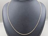 a gold chain necklace on a mannequin mannequin display