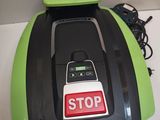 a green lawn mower with a stop sign on it