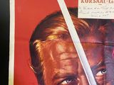 a poster of a man holding a sword in front of his face