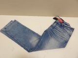 denim pants on a table with a cell phone on top of it