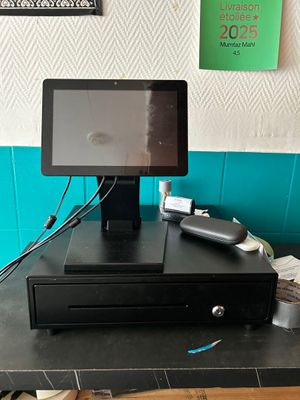 a tablet computer sitting on top of a cash register