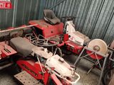 two red motorcycles parked next to each other in a garage