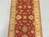 a red and gold runner rug on a white background