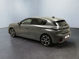 the rear end of a grey car in a room