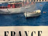 a poster of a boat in the water with a city in the background