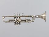 a silver trumpet that is flying in the air
