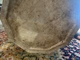 someone is holding a large bowl on a rug in a room