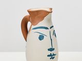 une image représentant un vase blanc et bleu sur lequel est peint un visage