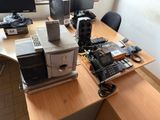 a desk with a lot of electronics on top of it