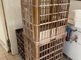 a stack of crates sitting in a kitchen next to a refrigerator