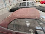 many old cars that are parked in a garage