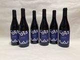 six bottles of wine sitting on top of a white table