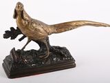 bronze statue of a pheasant on a wooden base on a white background