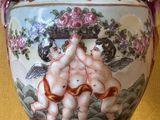 a vase with a painting of two cherenskers on it