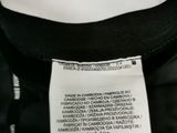 the back of a black and white jacket with a label on it