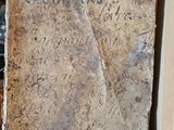 a stone with writing on it sitting in a box