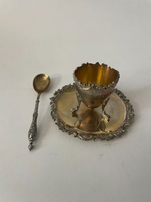 a silver plate with a spoon and a spoon rest on it