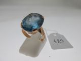 a close up of a ring with a blue stone on it