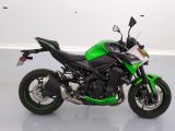 a picture of a green and black motorcycle parked in a room