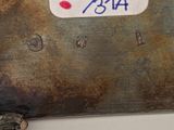 a close up of a metal object with a sticker on it