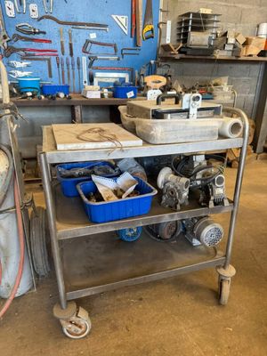 un chariot métallique chargé d'outils dans un garage