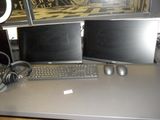 two computer monitors and a keyboard on a desk