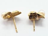 pair of pearl and gold flower earrings on a white surface