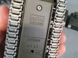 a person holding a small metal device in their hand