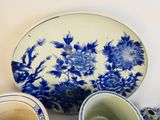 a blue and white plate and two cups on a table