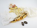 two pairs of shoes and a dress laying on the floor