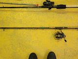 a person standing on a yellow floor next to a fishing rod and reel