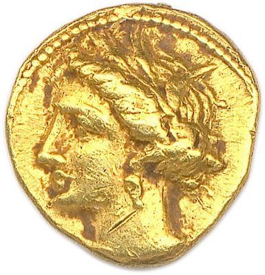 a close up of a gold coin on a white surface