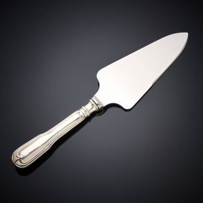 a close up of a knife on a table with a black background