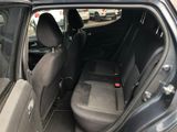 a black car with the door open and the seats down