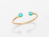 un bracelet en or orné de pierres turquoise