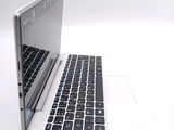 a white laptop with a black keyboard on a white surface