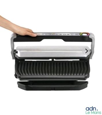 a close up of a person holding a sandwich maker in their hand